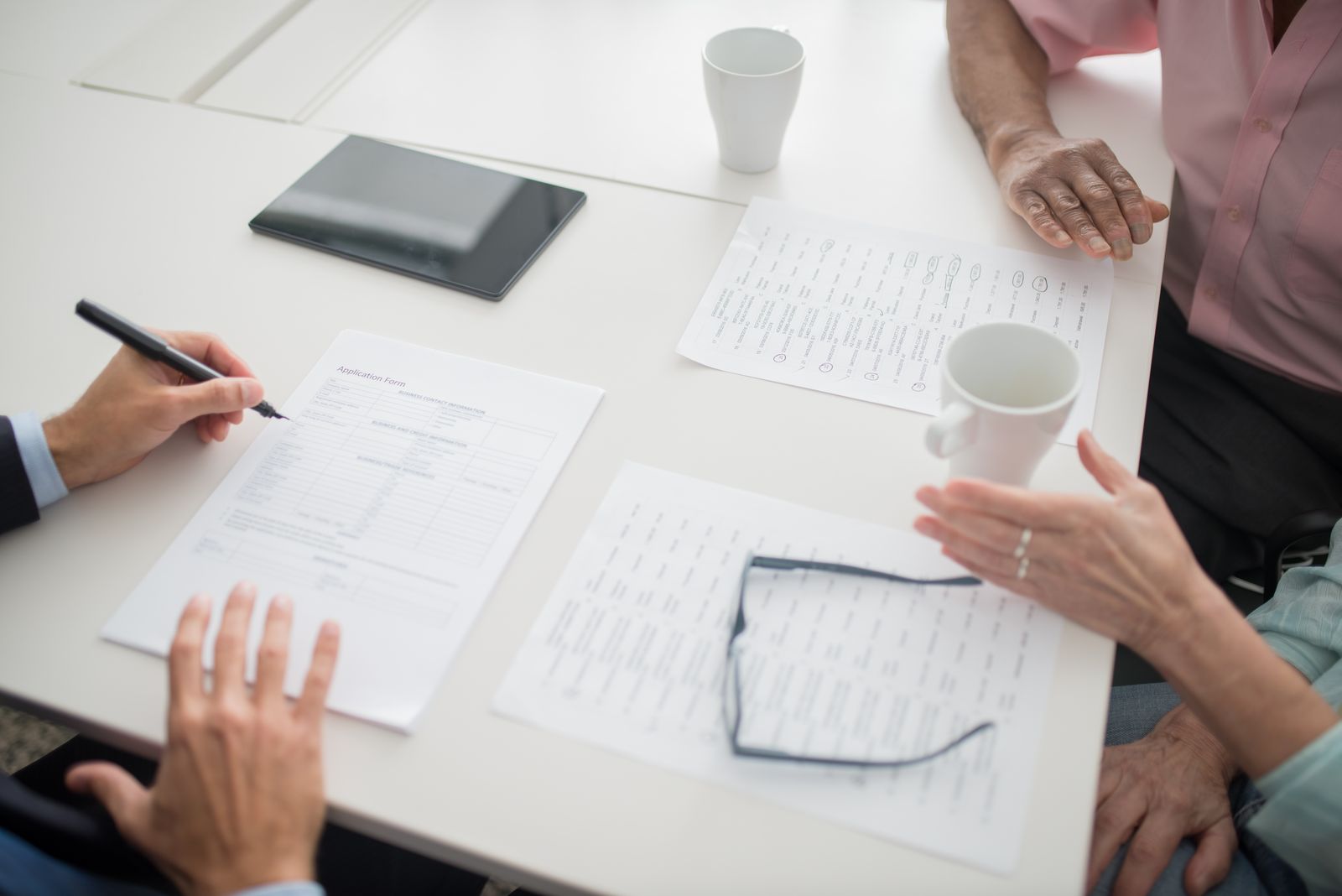 Two owners reviewing documents with an attorney