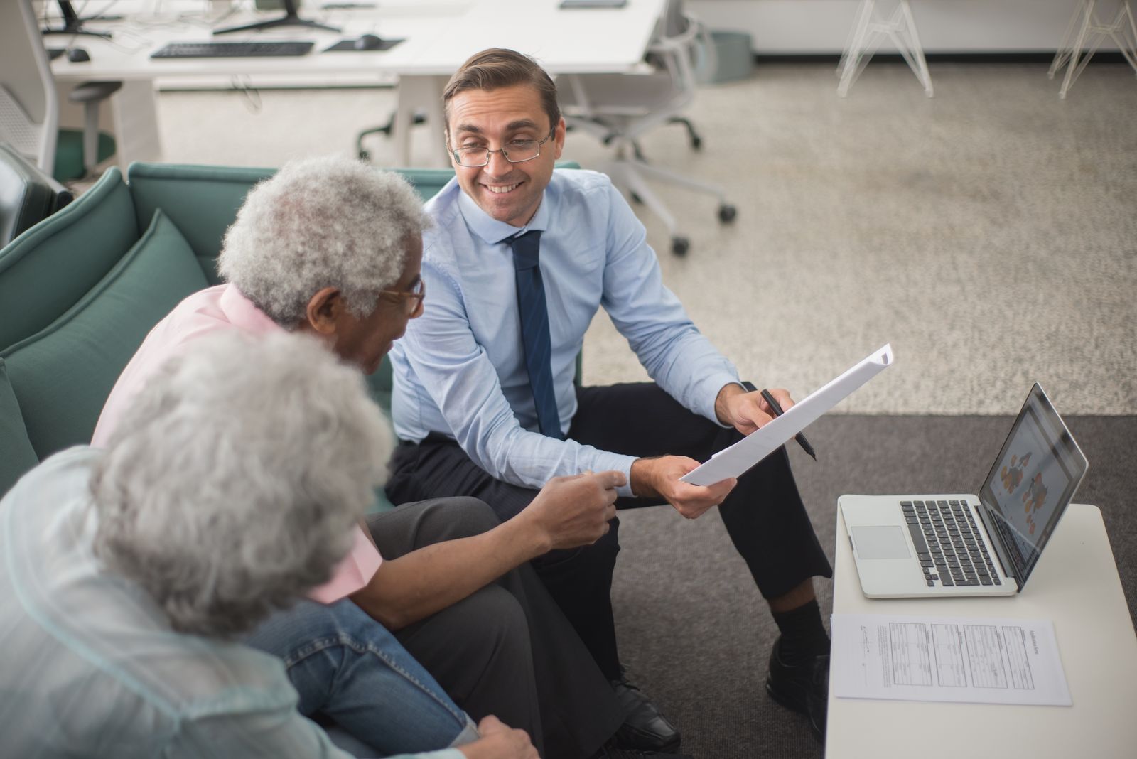Attorney reviewing financial documents with senior clients